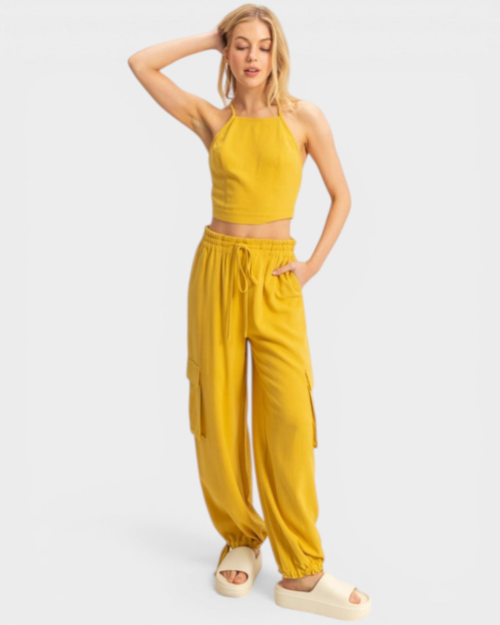 Woman wearing a yellow outfit on a white background