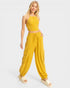 Woman wearing a yellow outfit with a top and wide-leg pants on a white background