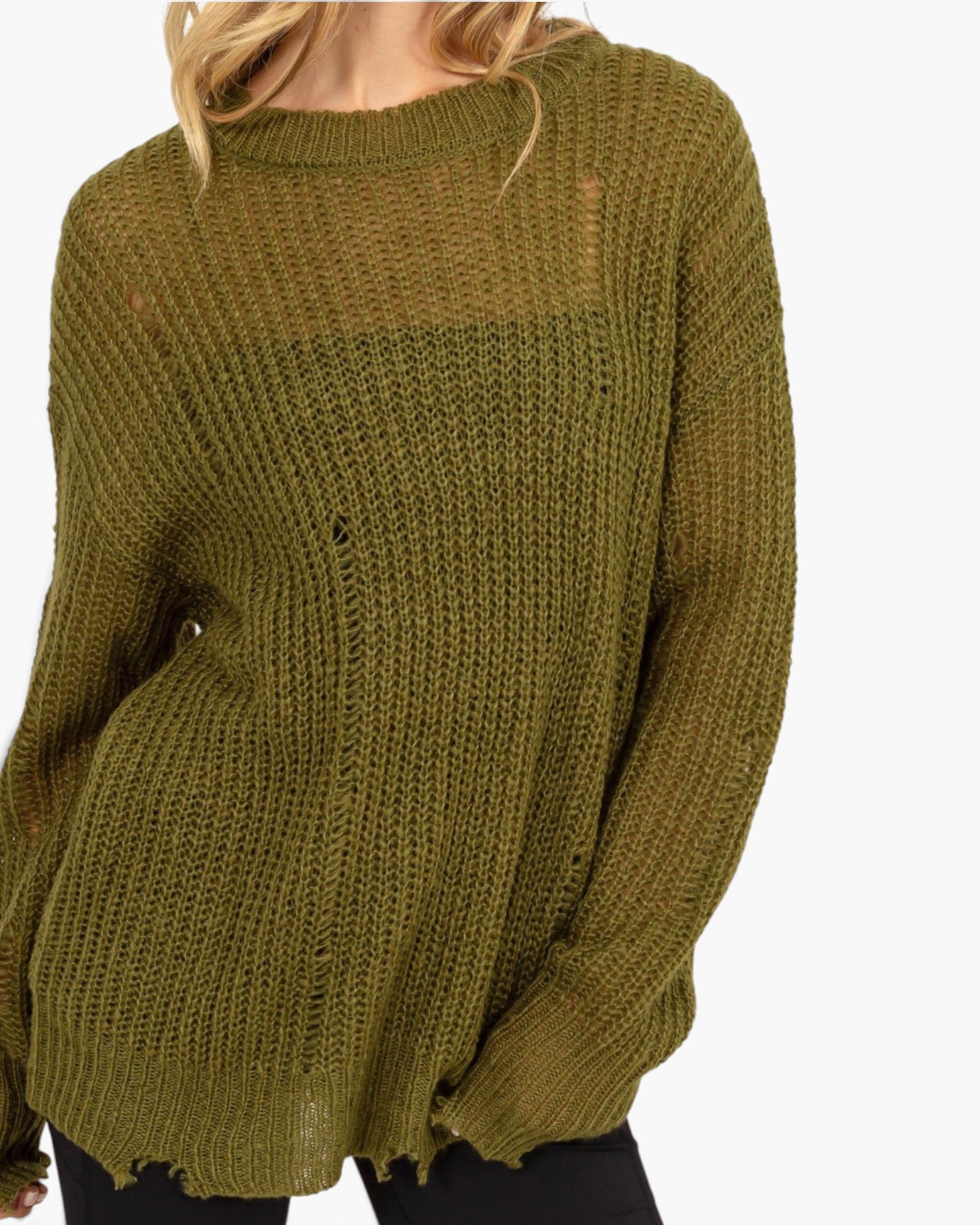 An olive green chunky knit sweater with distressed details, worn by a model against a plain white background.