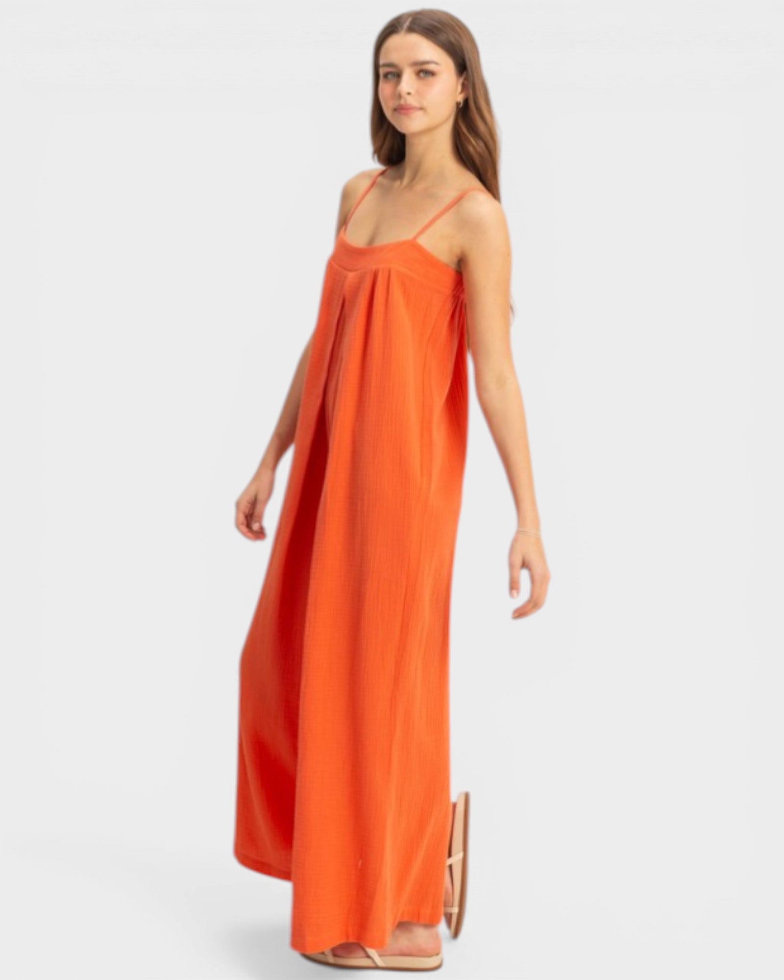 Woman wearing an orange dress on a white background