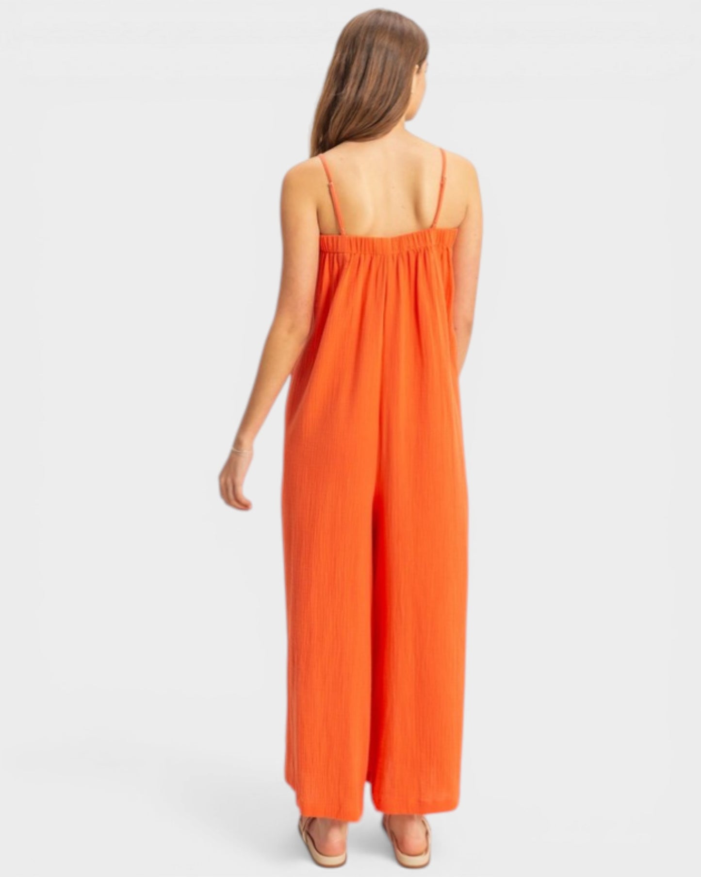 Woman wearing an orange dress on a white background
