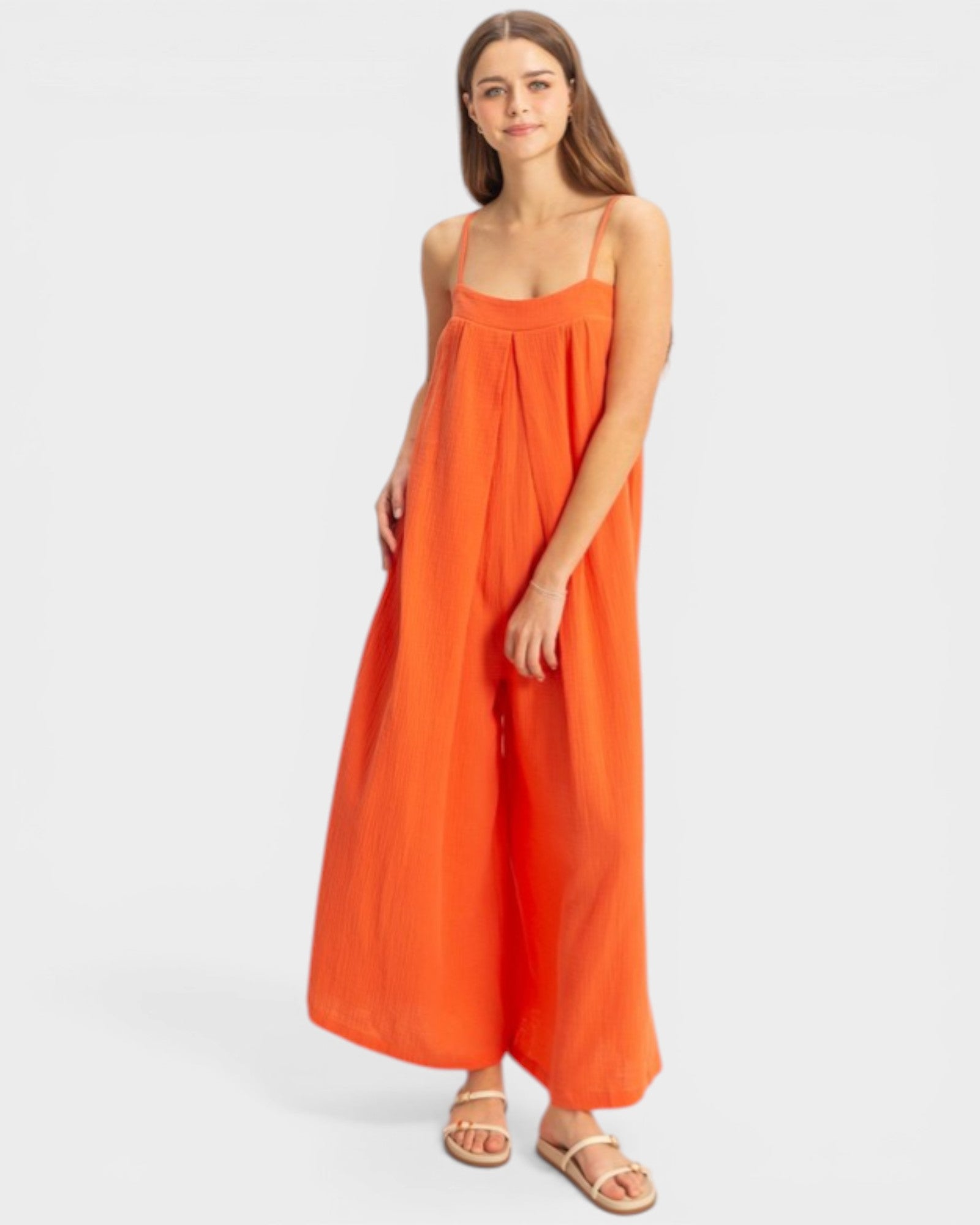 Woman wearing an orange dress on a white background