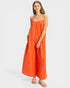 Woman wearing an orange dress on a white background