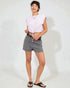 Person wearing a light purple top and gray shorts on a white background