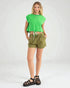 Woman wearing a green crop top and olive green shorts on a white background