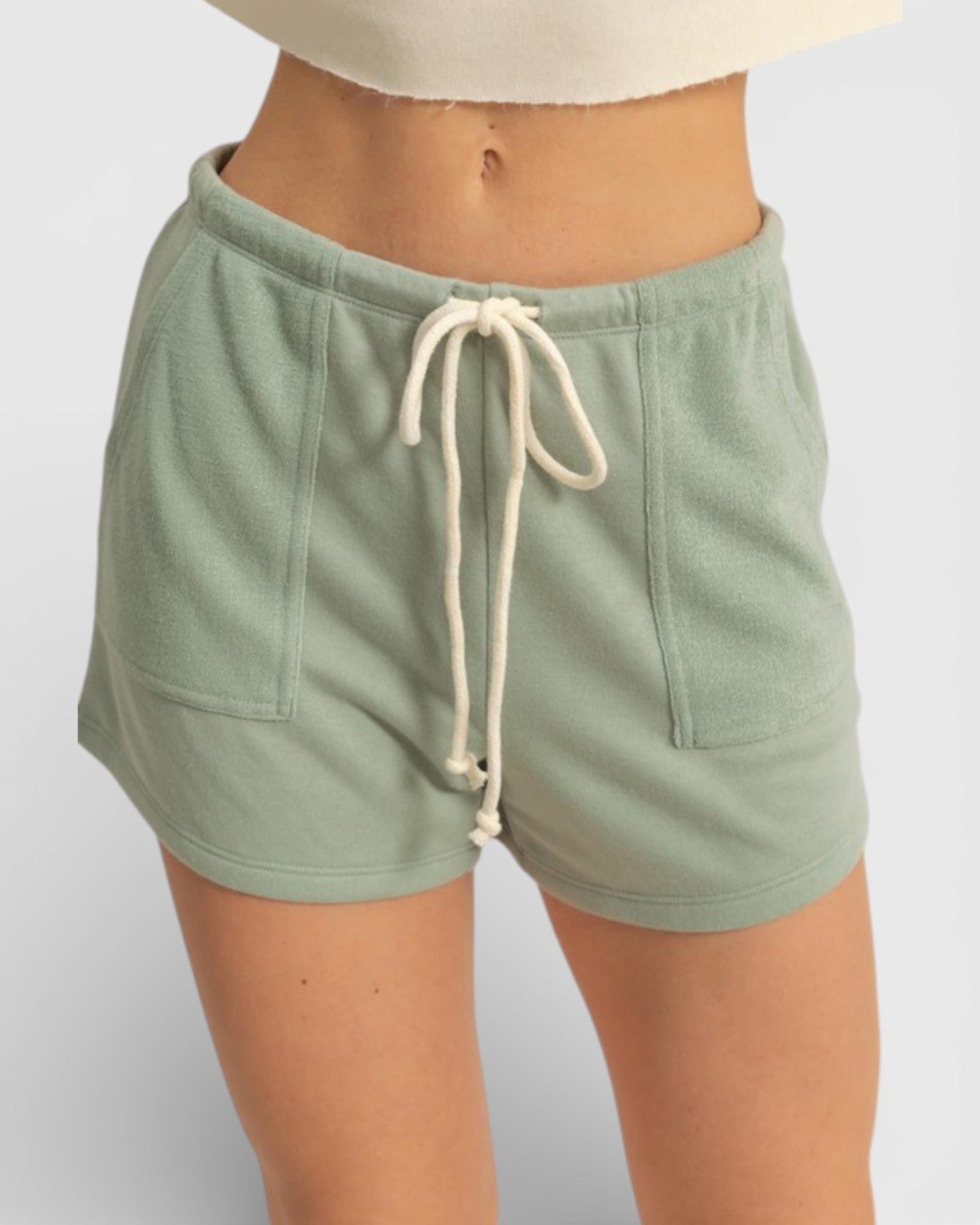 Green shorts with a drawstring on a white background