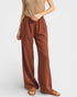 Brown wide-leg pants worn by a person on a white background