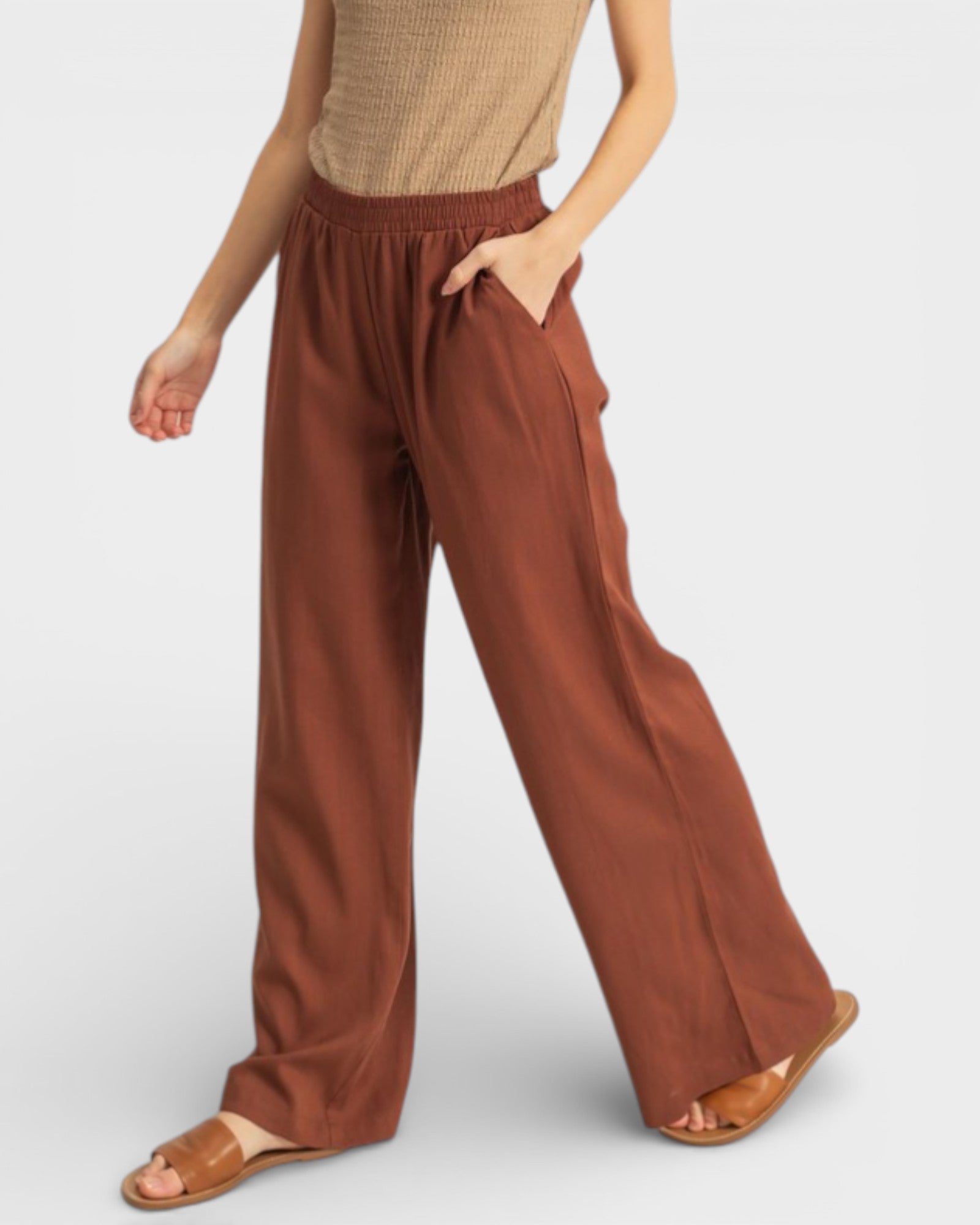 Brown wide-leg pants worn by a person on a plain background