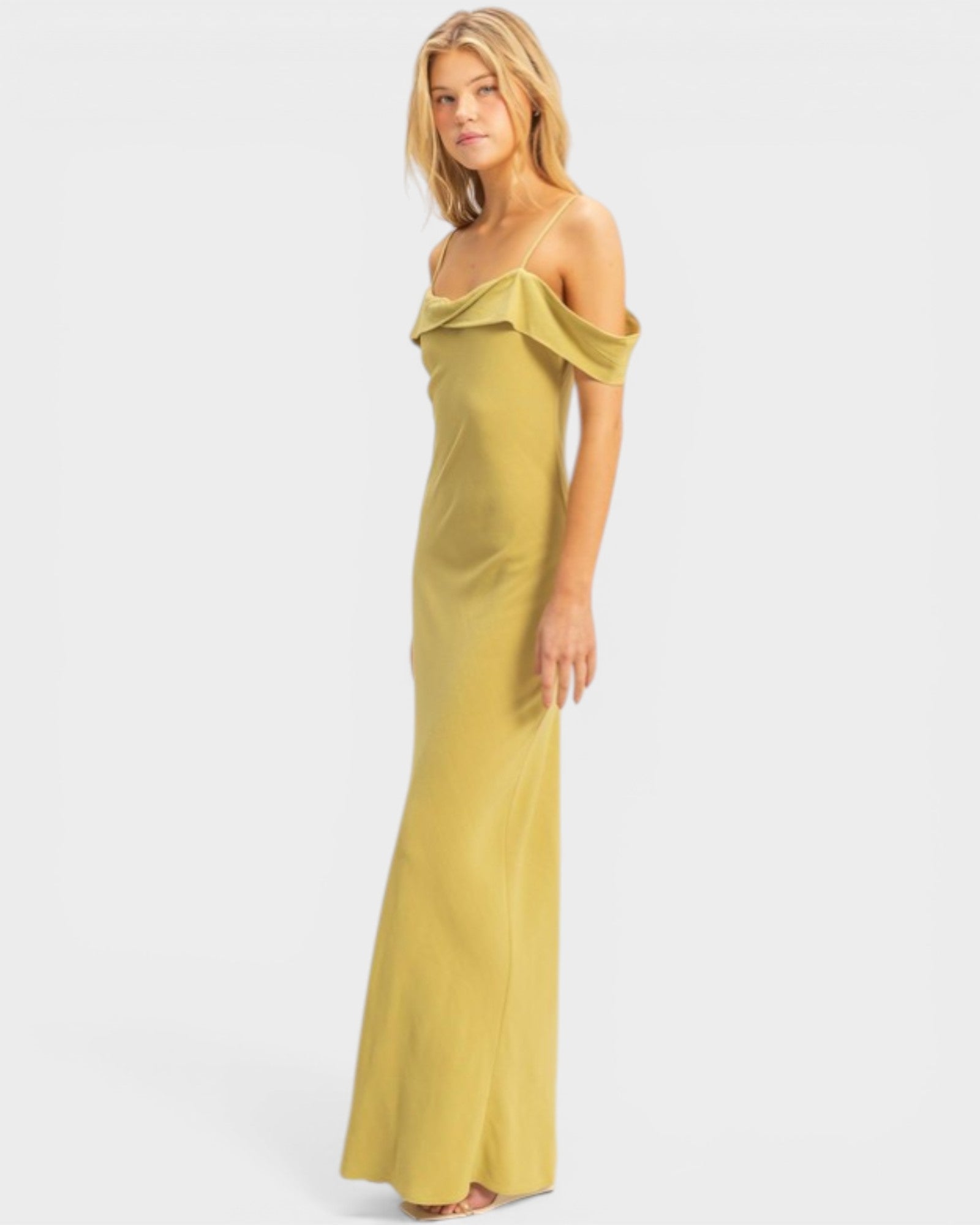 Woman wearing a yellow off-shoulder dress on a white background