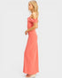 Woman wearing a coral off-shoulder dress on a white background