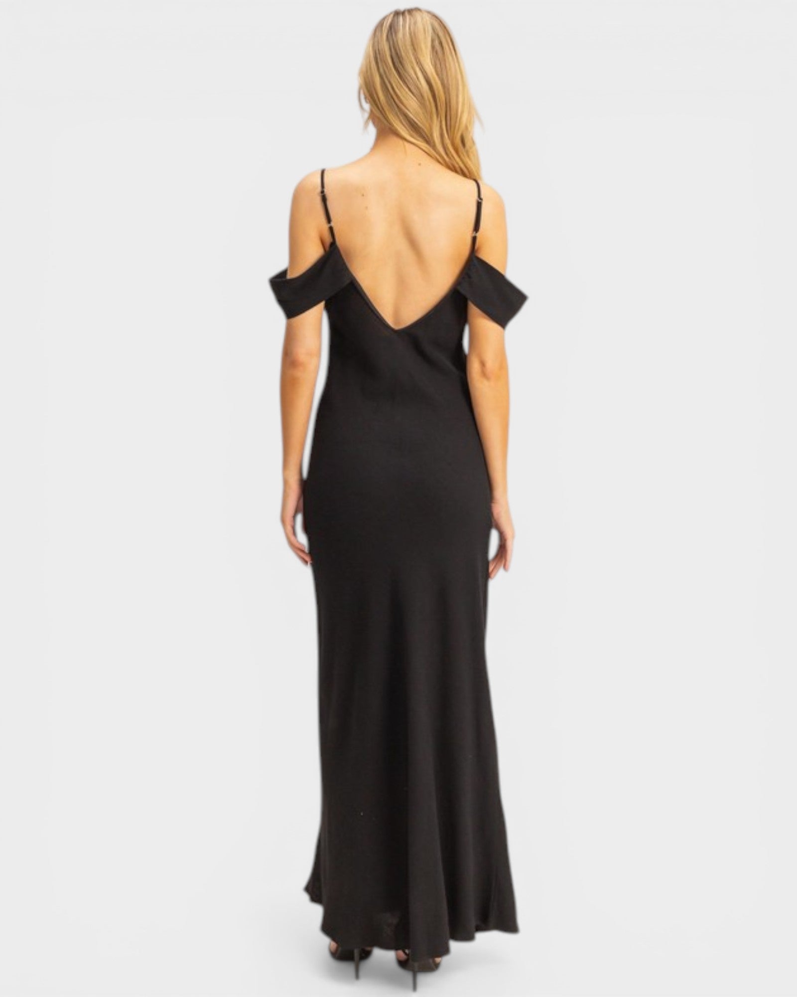 Black evening gown with open back on a white background