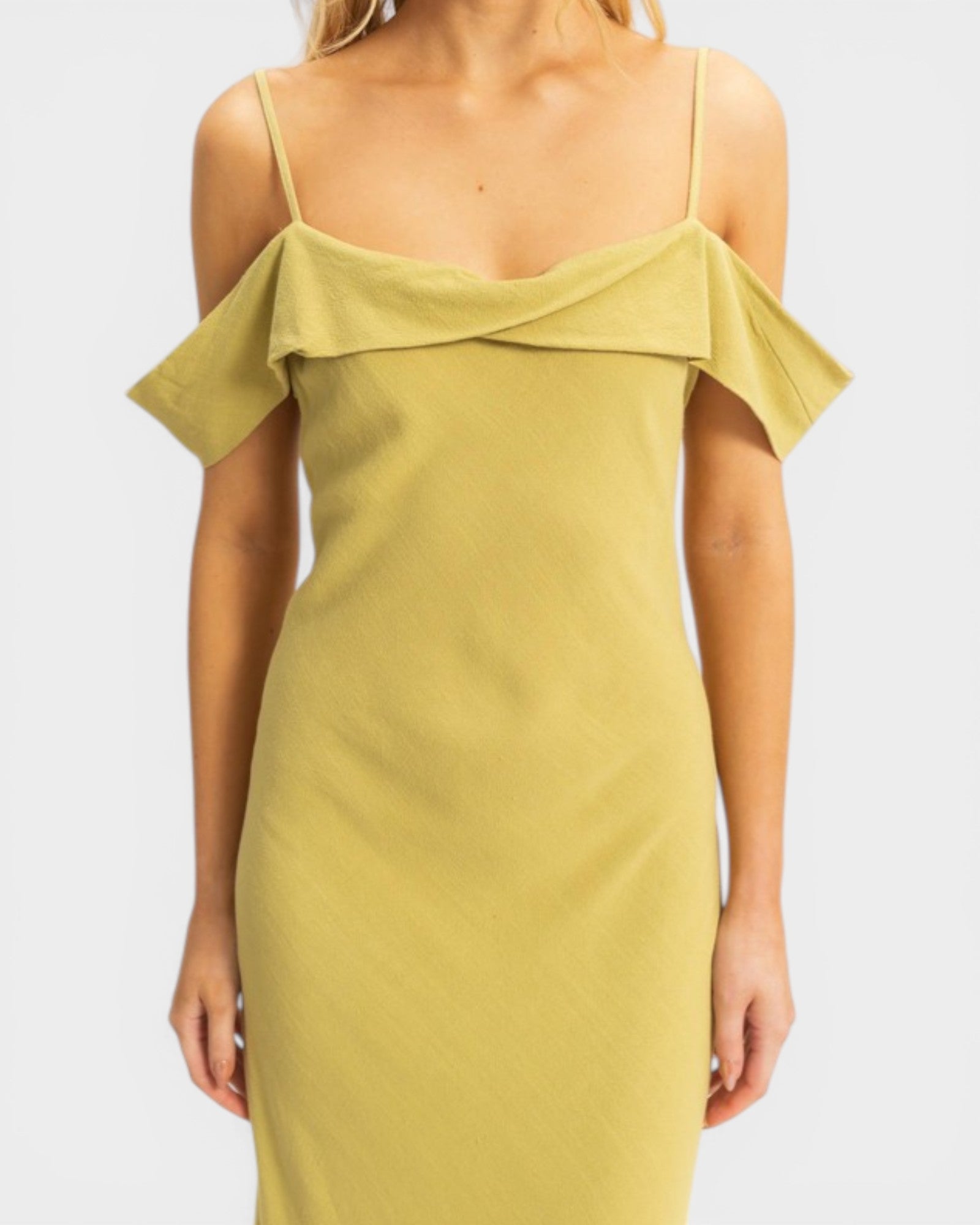 Yellow off-shoulder dress worn by a person on a white background