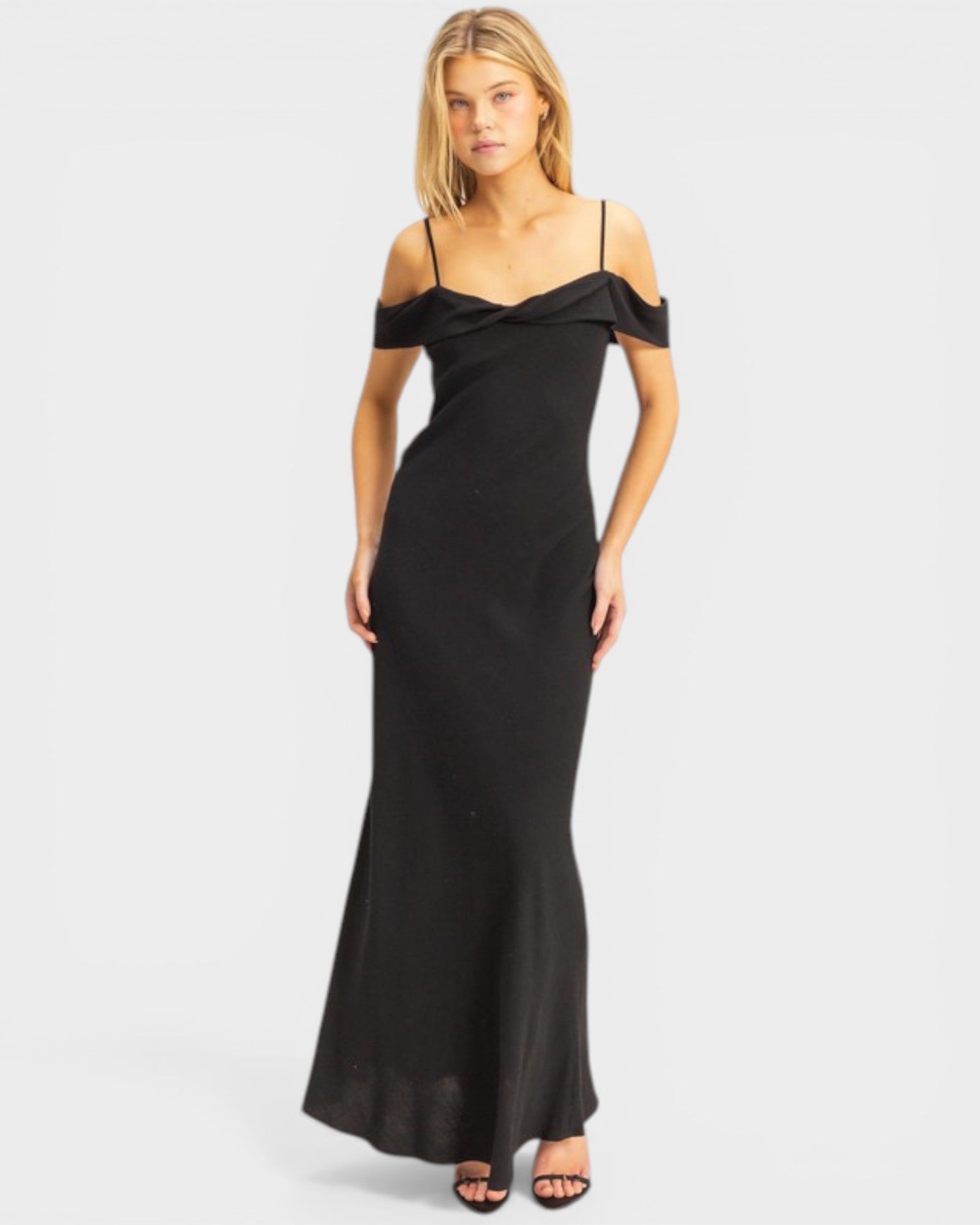 Woman wearing a black off-shoulder gown on a white background