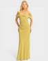 Woman wearing a yellow off-shoulder gown on a white background