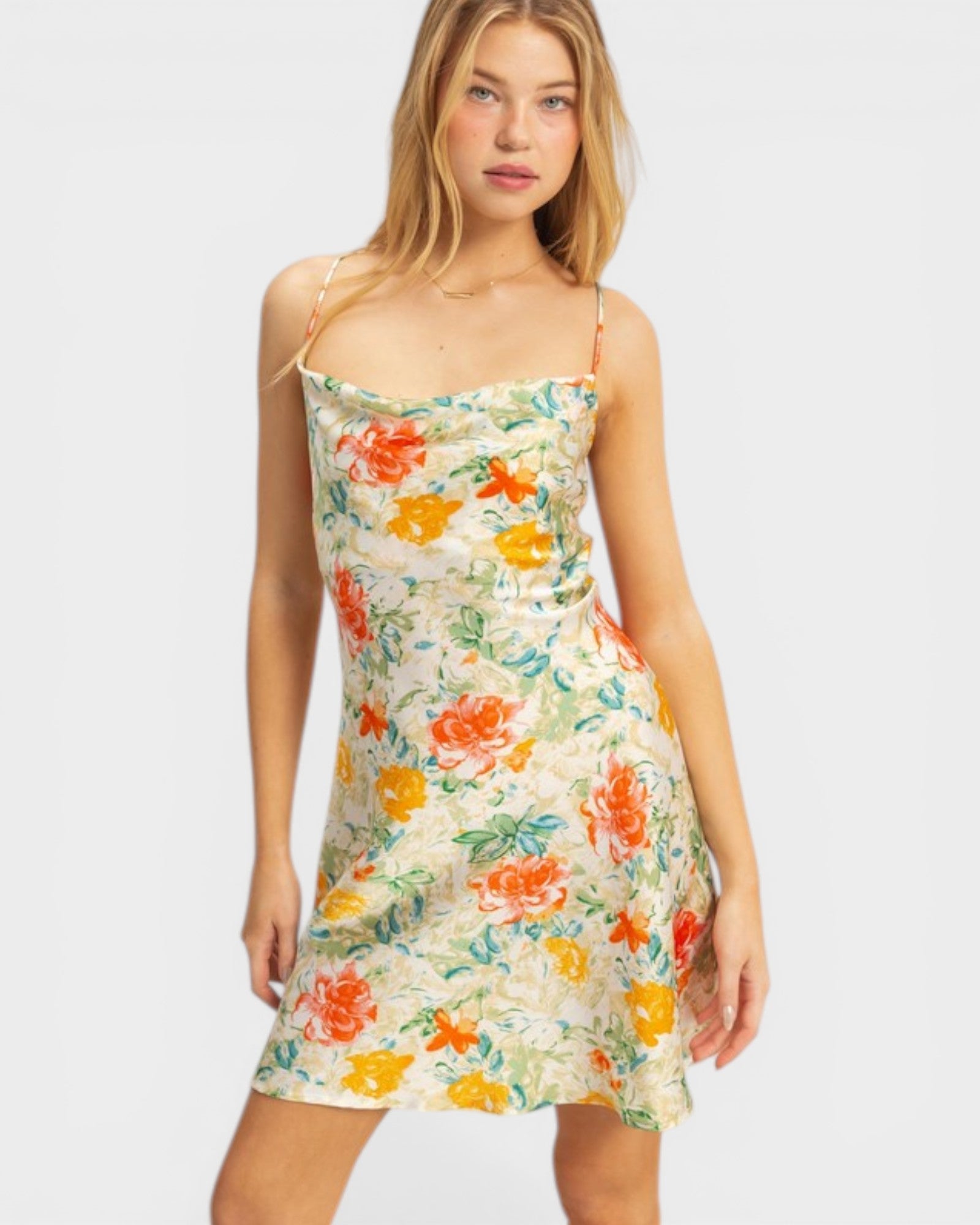 Woman wearing a floral dress with a plain background