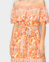 An off-the-shoulder orange floral dress with a ruffled neckline, a matching fabric tie belt, and intricate silver patterned trim, shown on a model against a light gray background.