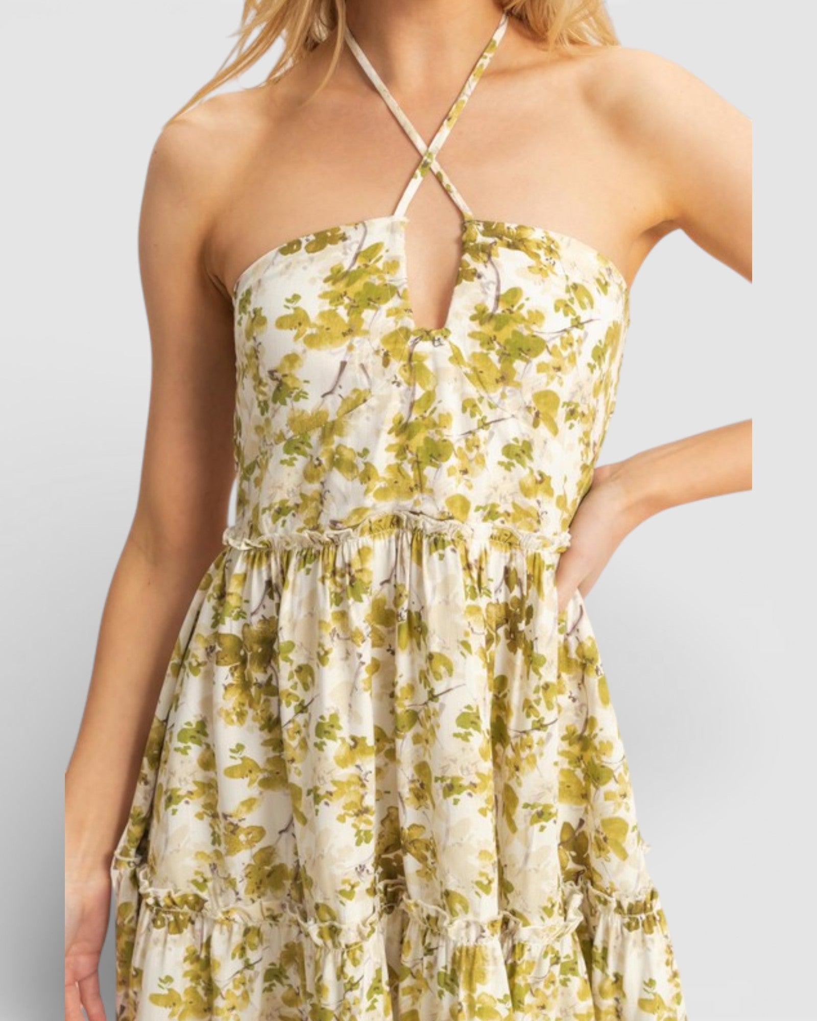 Woman wearing a floral dress with a plain background