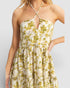 Woman wearing a floral dress with a plain background
