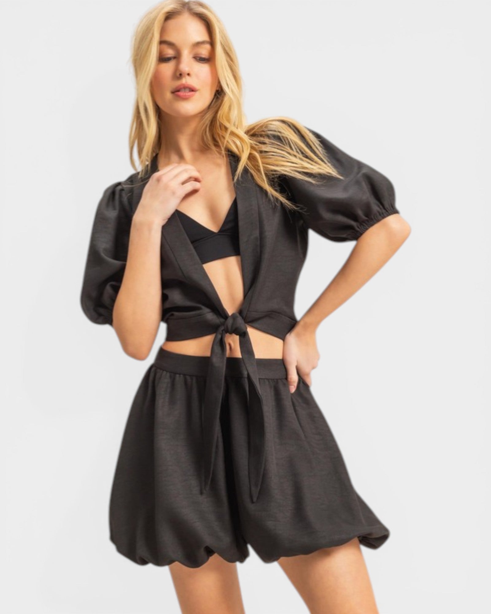 Woman wearing a black outfit with a white background