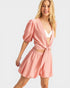 Woman wearing a pink outfit with a white background