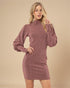 Woman wearing a maroon ribbed dress against a beige background
