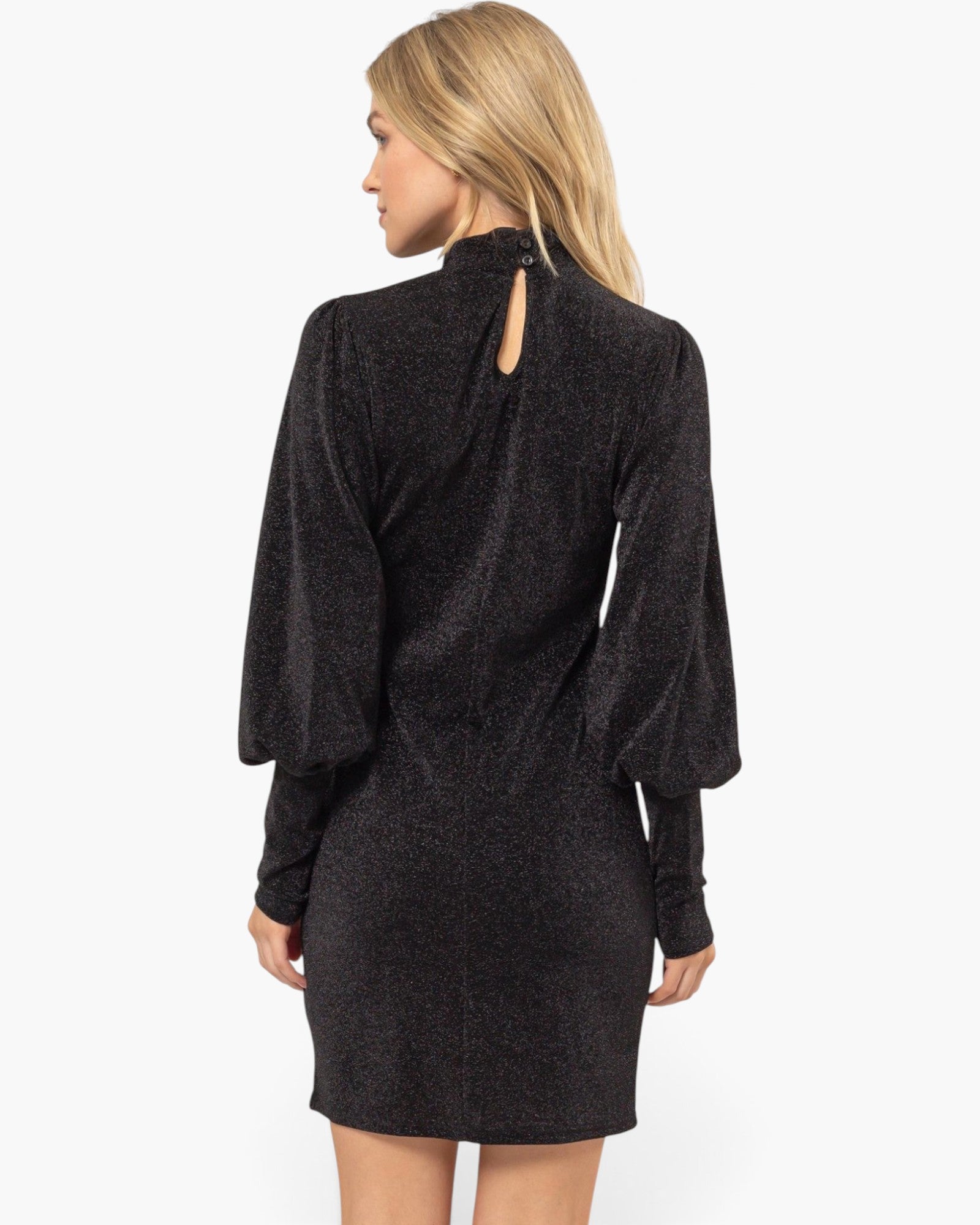 A woman shown from the back wearing a dark charcoal gray textured long-sleeve dress with a keyhole cutout at the neck, set against a plain white studio background.