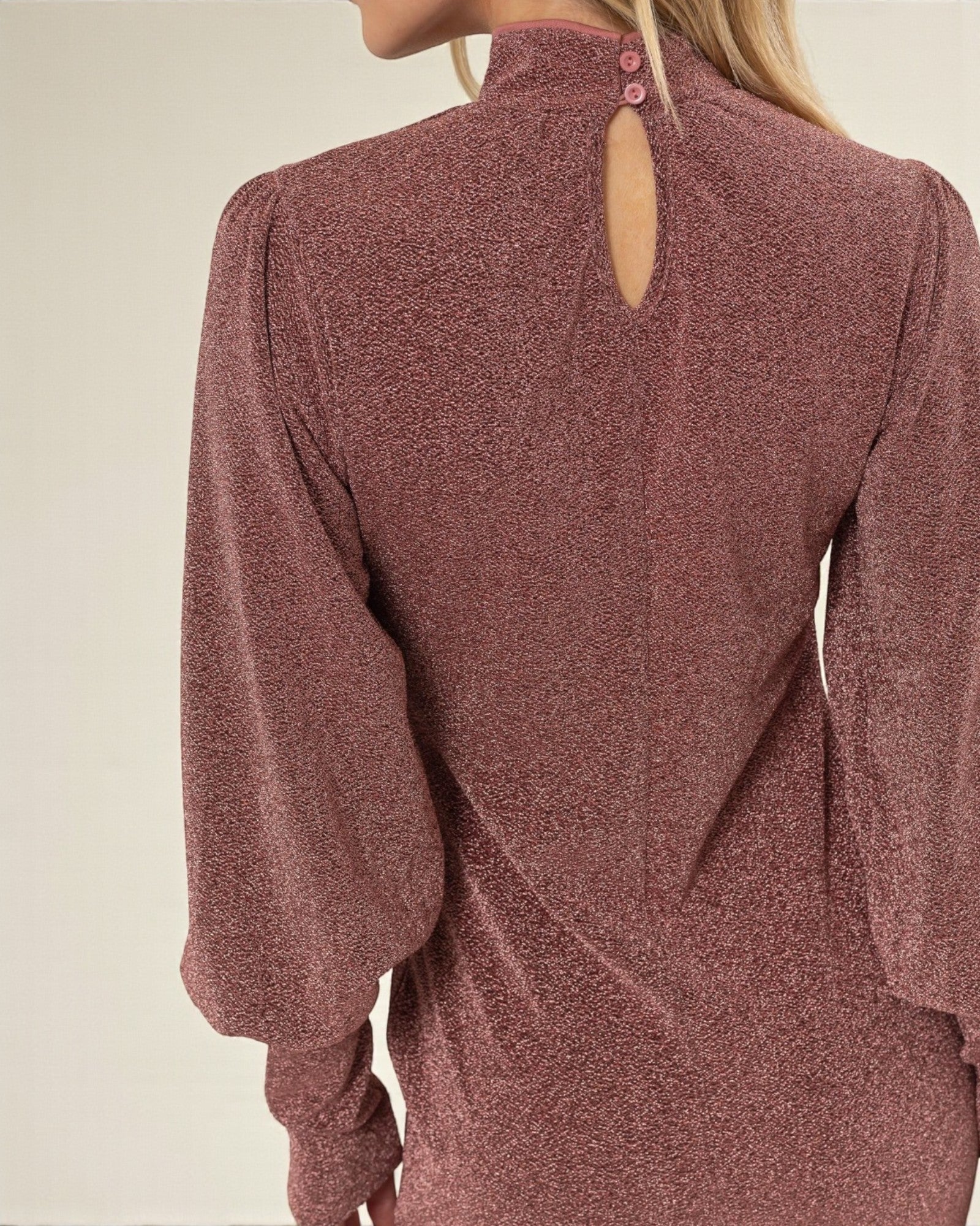 Mauve long-sleeve top with a cut-out back design on a neutral background