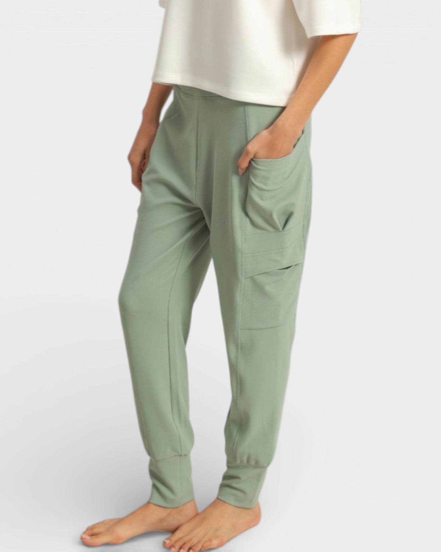 Person wearing green pants on a white background