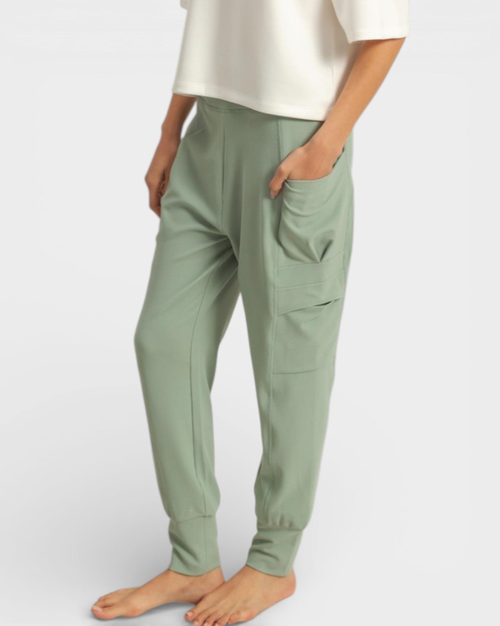 Person wearing green pants on a white background