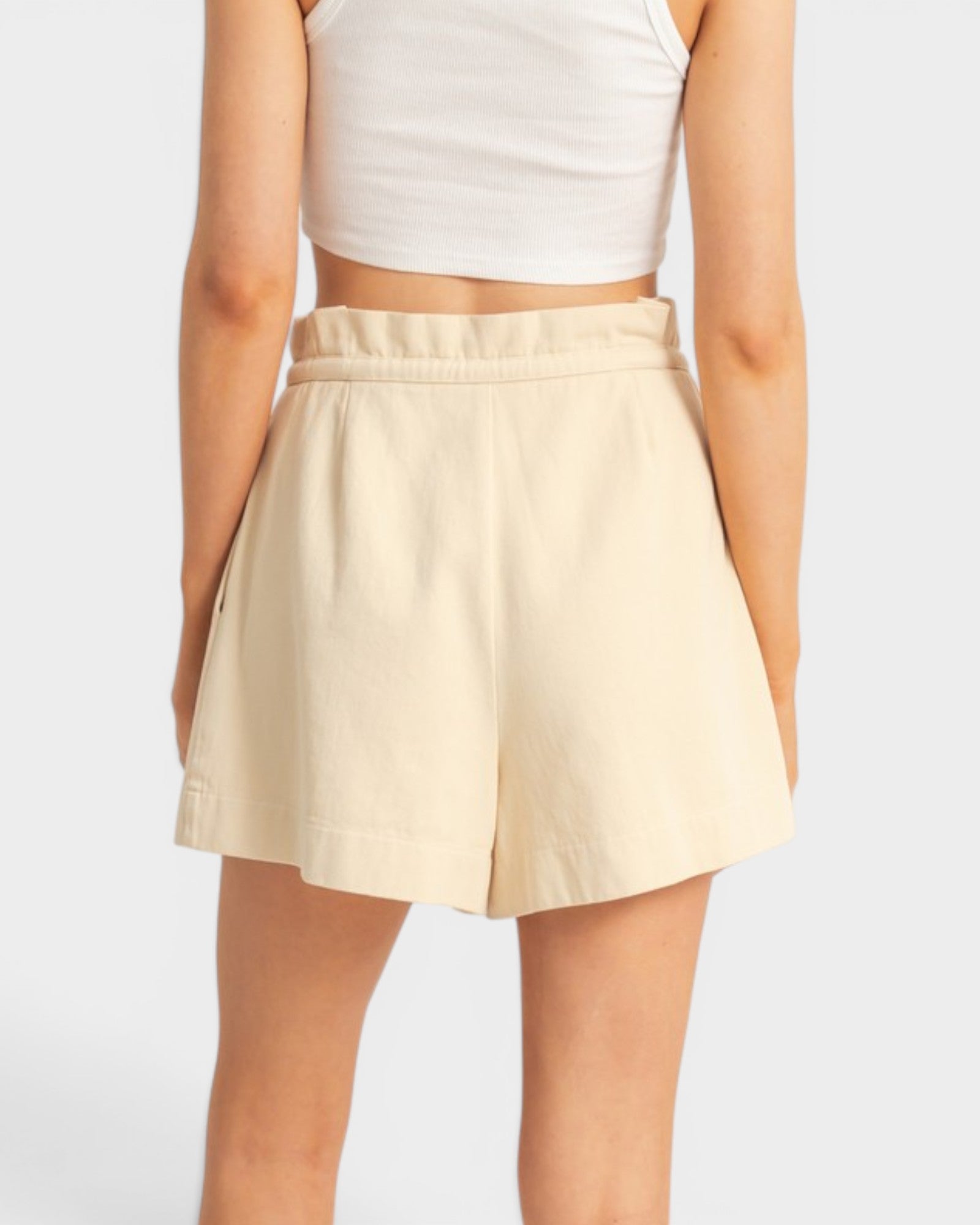 Beige skirt worn by a person on a white background