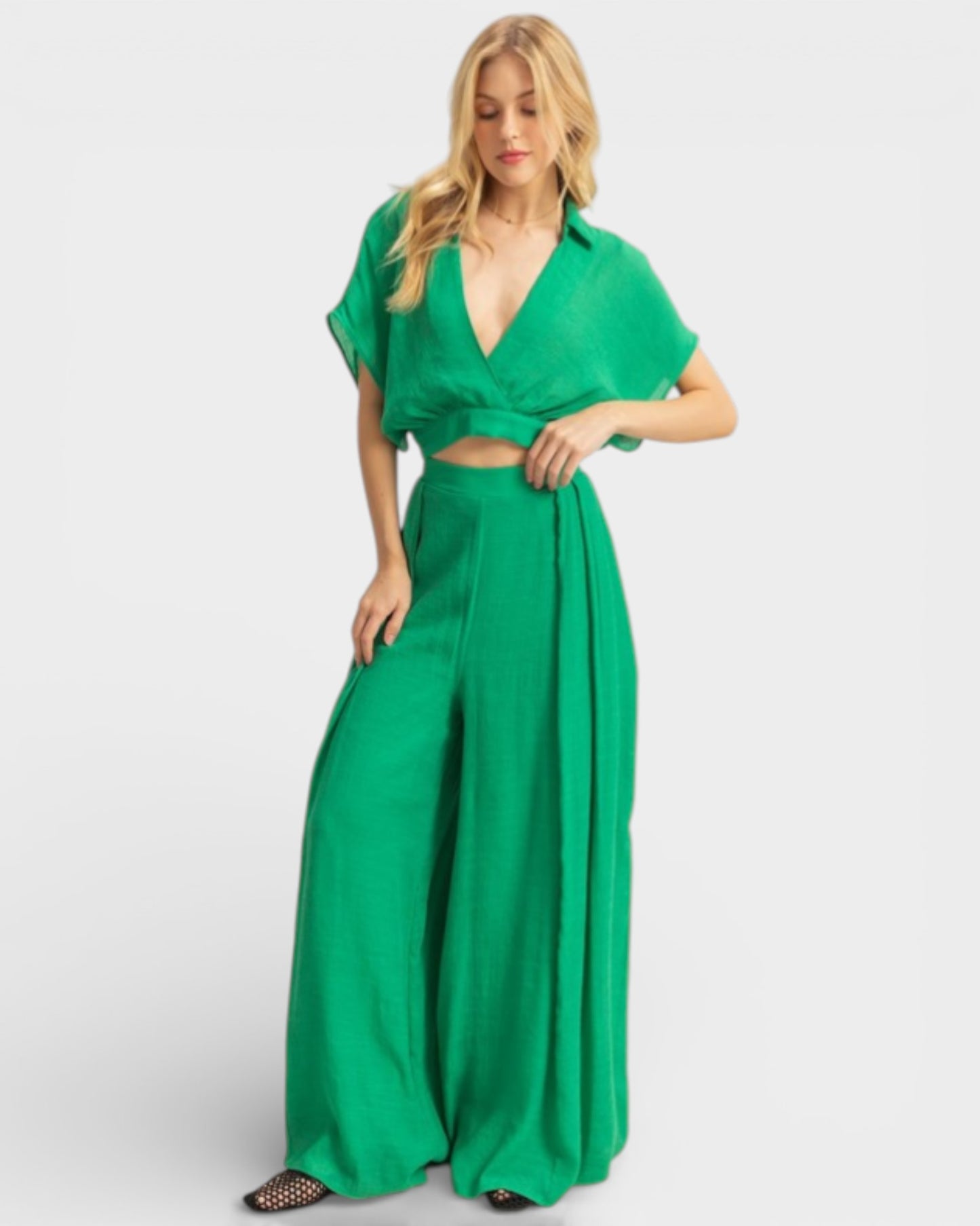 Woman wearing a green jumpsuit on a white background