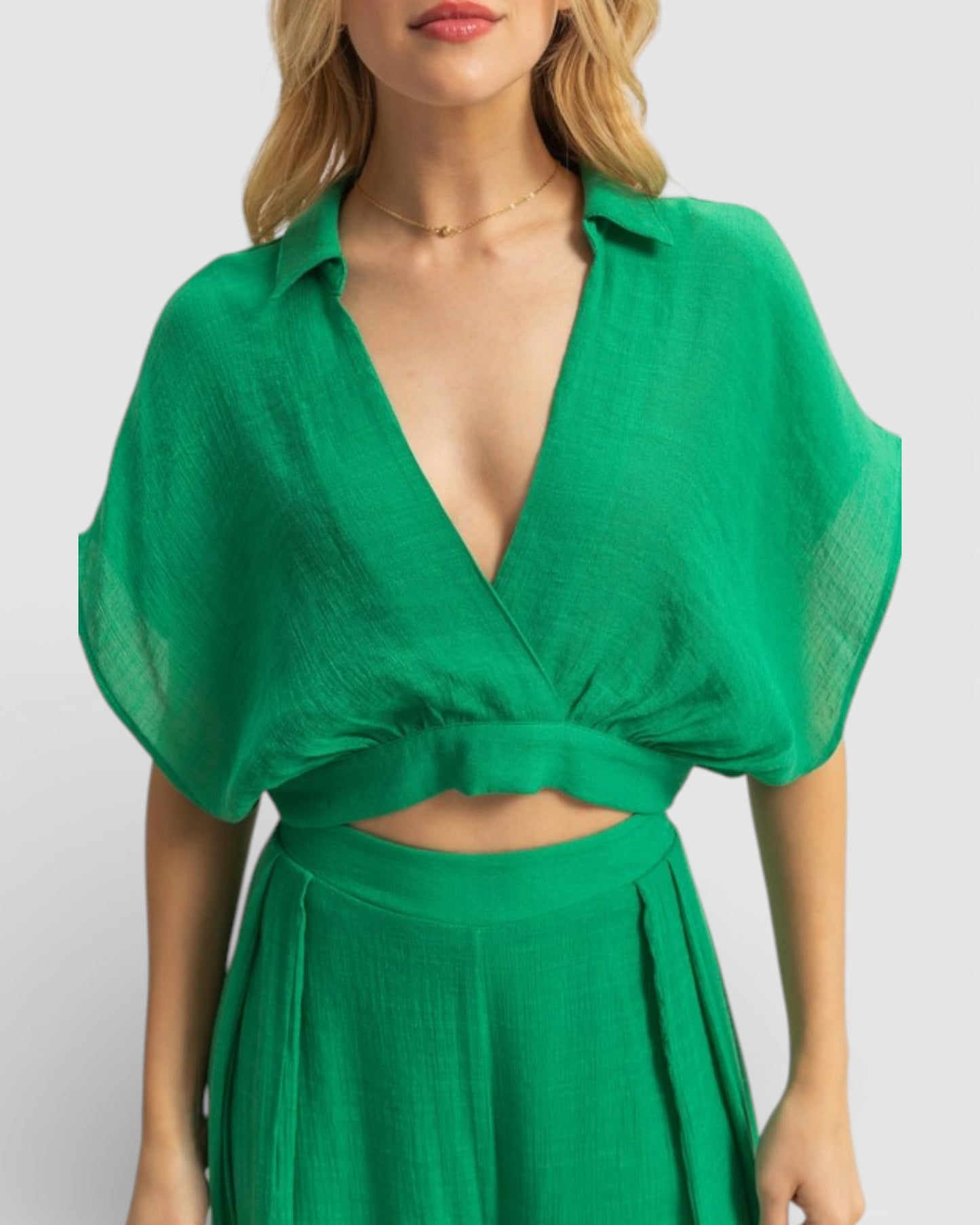 Green dress worn by a model on a white background