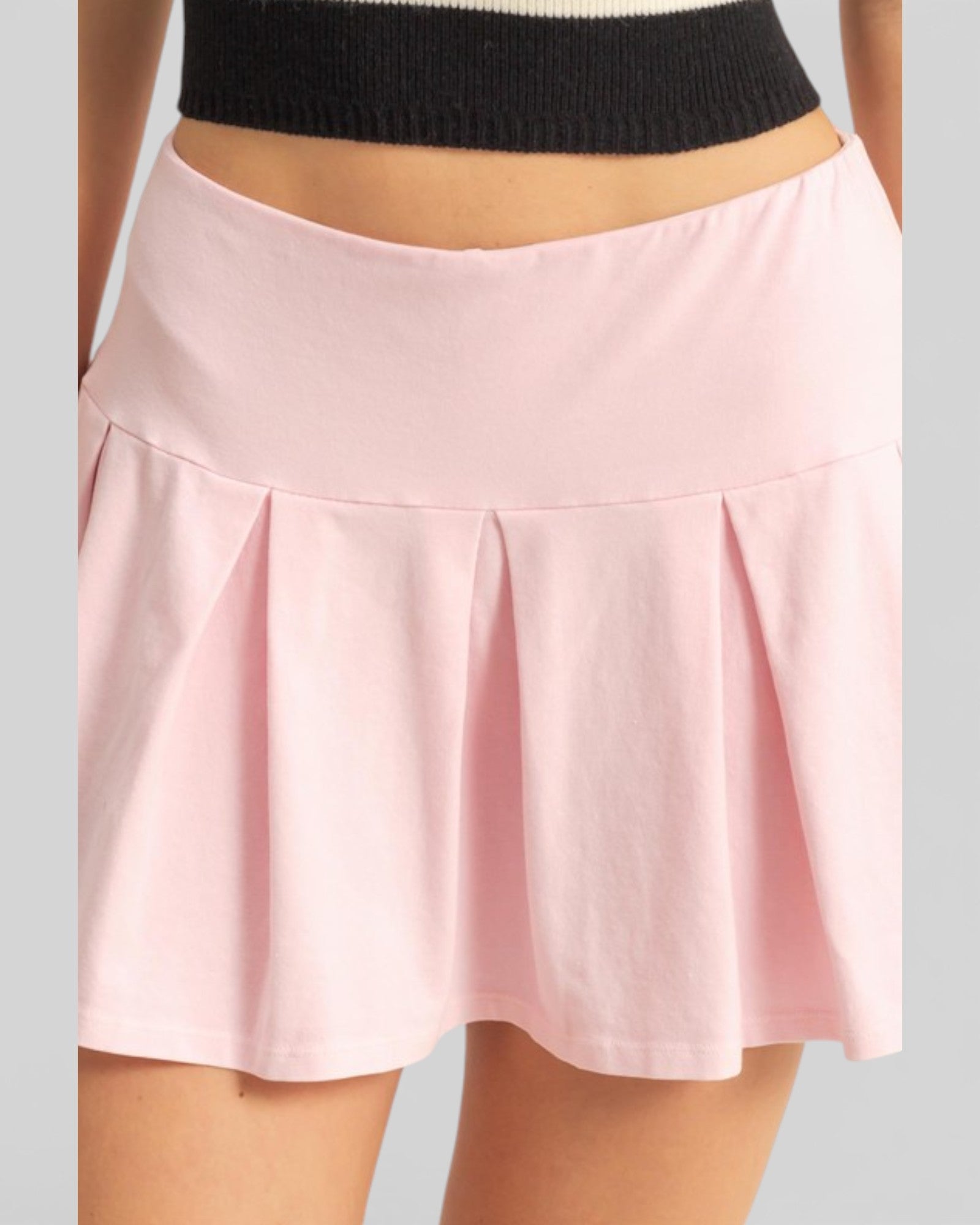 Pink skirt worn by a person on a gray background