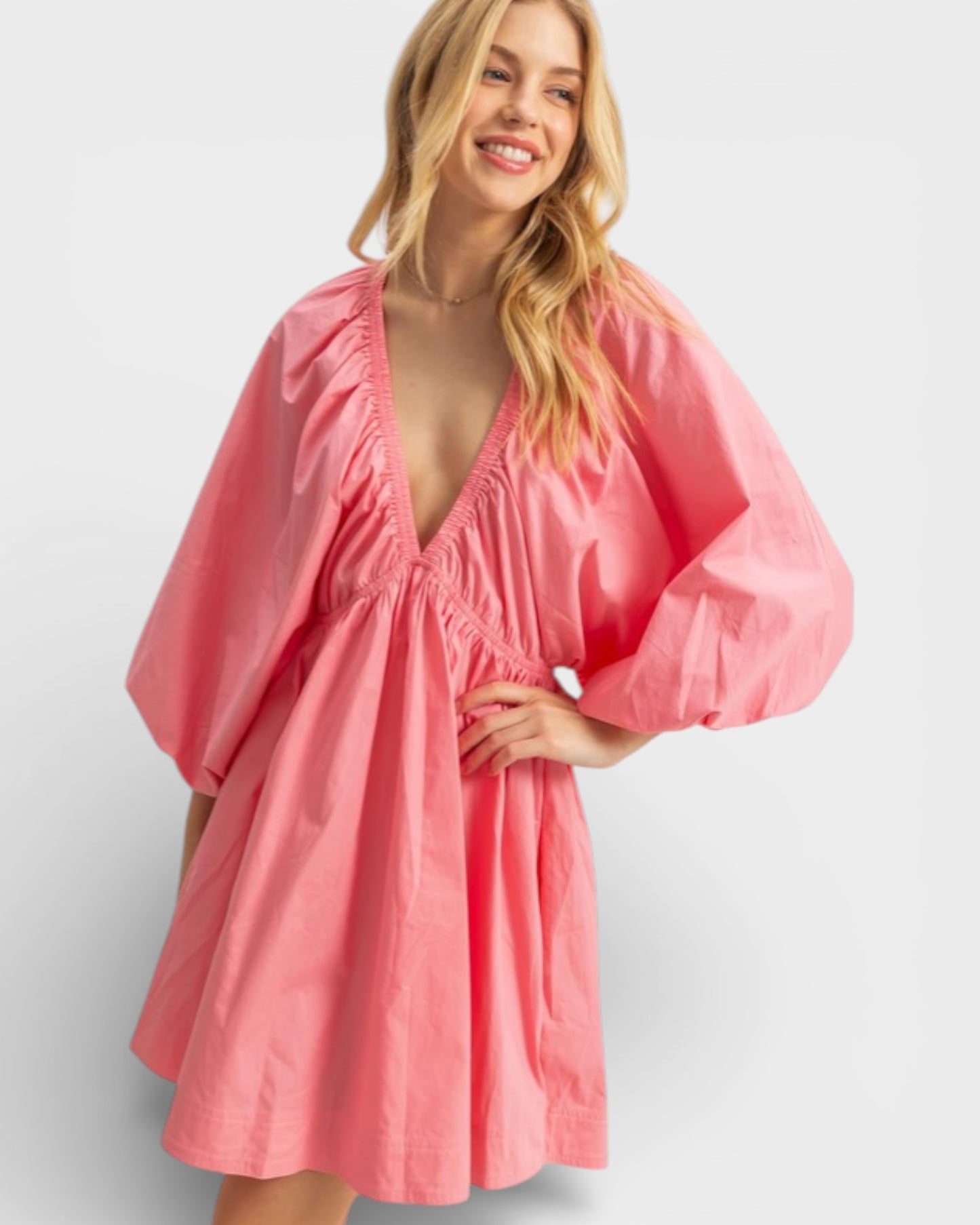 Woman wearing a pink dress on a white background