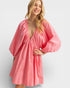 Woman wearing a pink dress on a white background