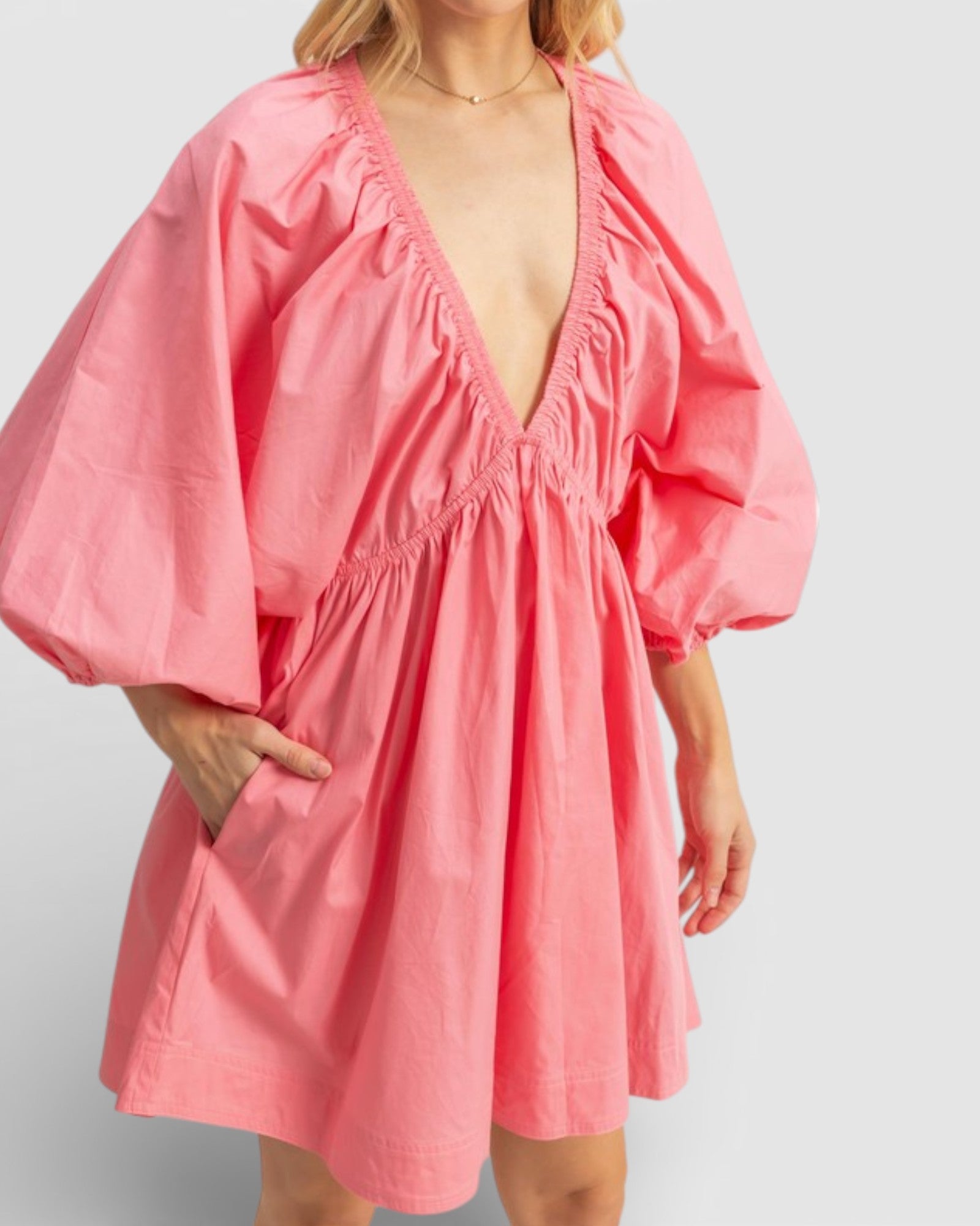 Pink dress with puff sleeves on a plain background