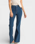 Person wearing blue flared jeans on a white background