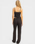 Black satin jumpsuit worn by a model on a white background
