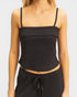 Black ribbed tank top worn by a person on a plain background