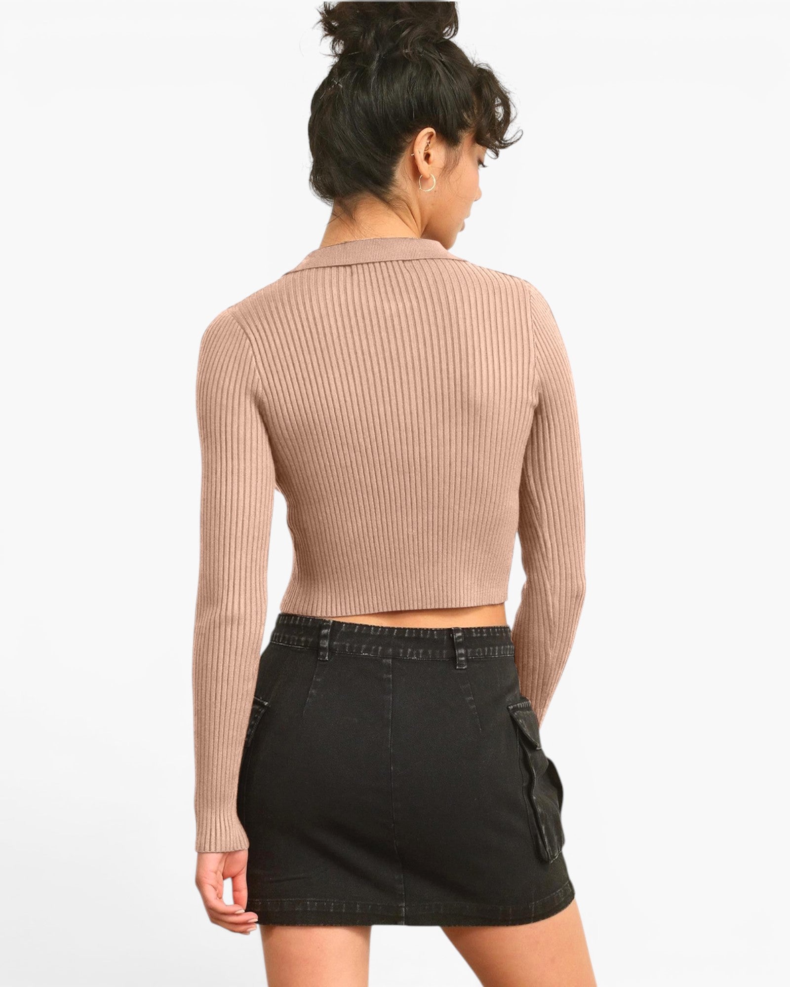 A woman shown from the back wearing a ribbed long-sleeve cropped top in a dusty rose color and a black denim mini skirt, against a plain white background.