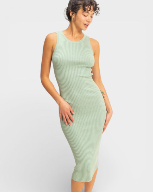 Woman wearing a light green ribbed dress on a white background