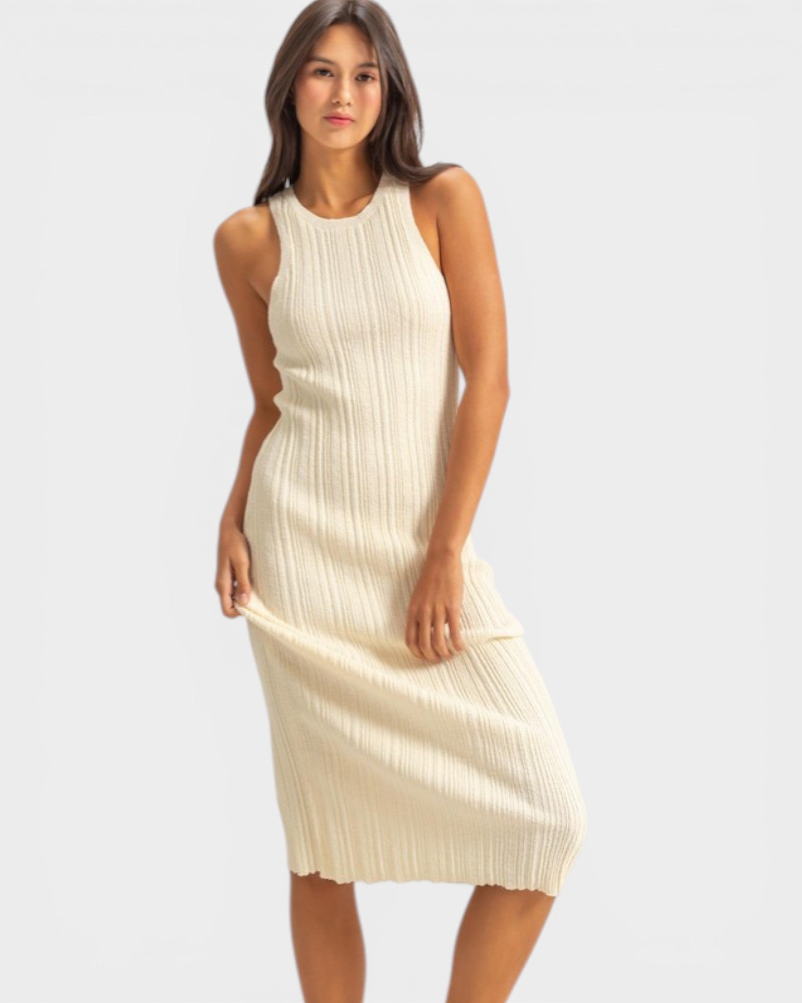 Woman wearing a beige sleeveless dress on a white background