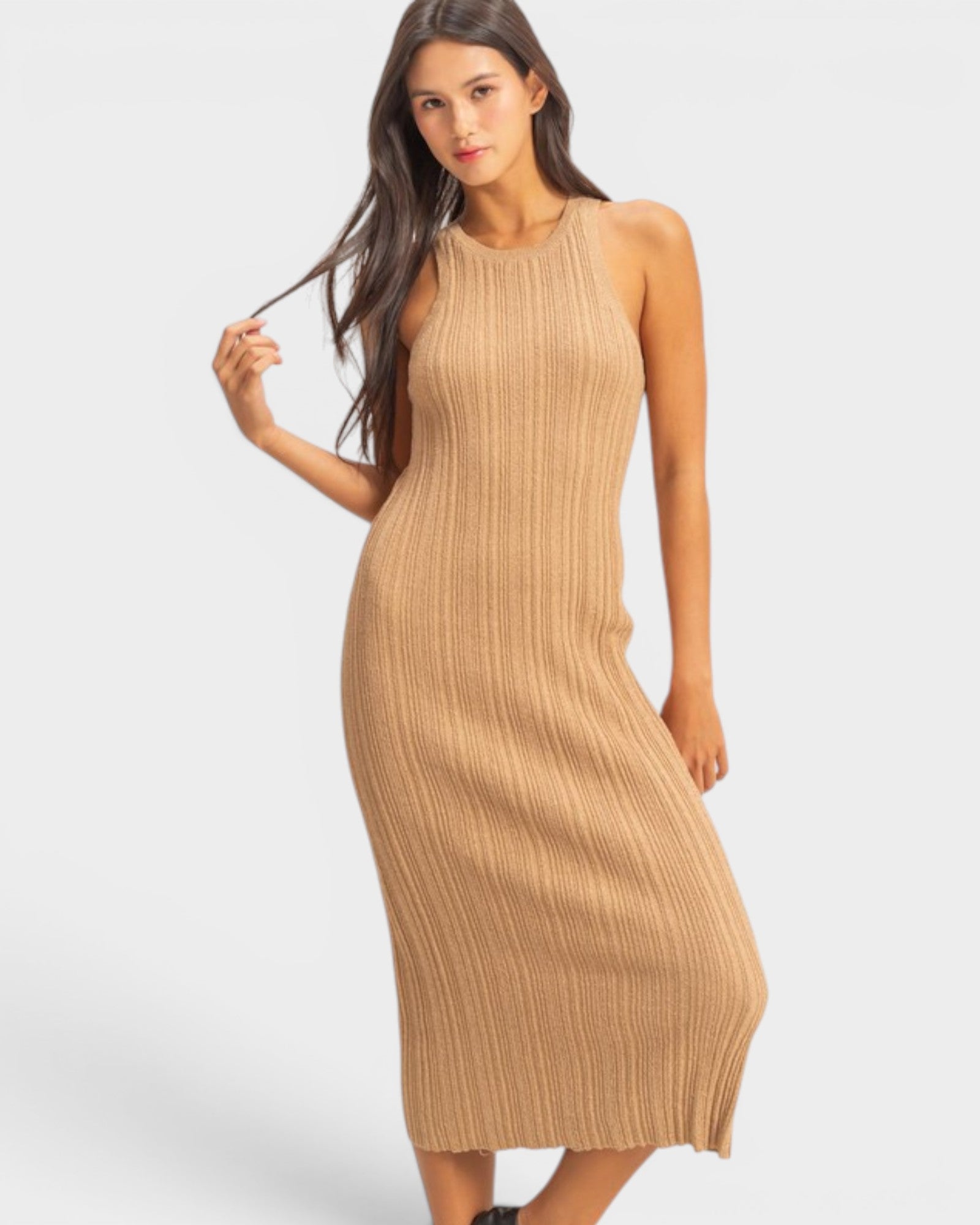 Woman wearing a beige ribbed dress on a white background