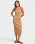 Woman wearing a beige ribbed dress on a white background