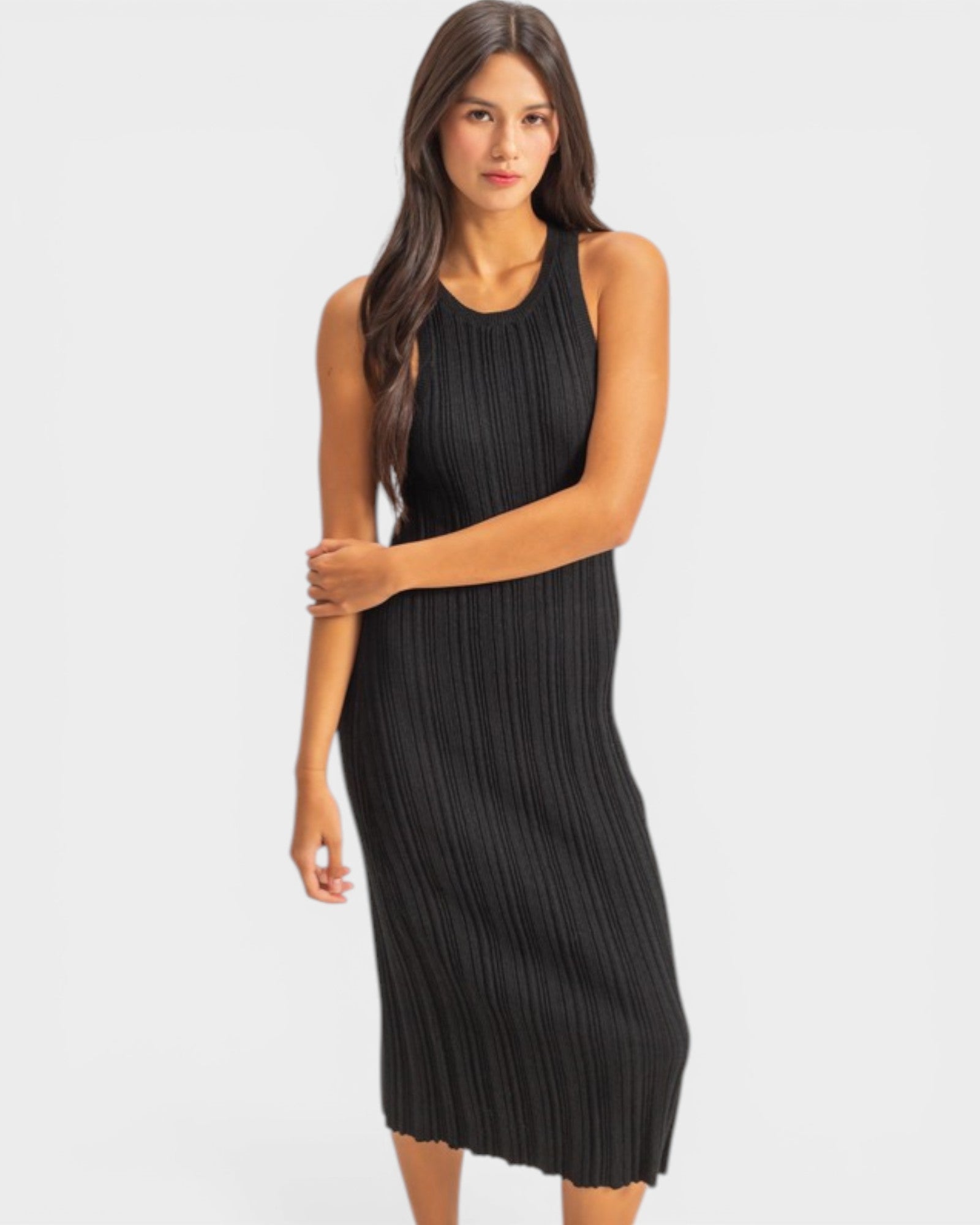 Woman wearing a black pleated dress on a white background