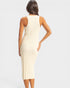 Woman wearing a beige ribbed dress on a light gray background