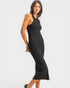 Woman wearing a black pleated dress on a white background