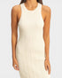 Woman wearing a beige ribbed dress against a white background