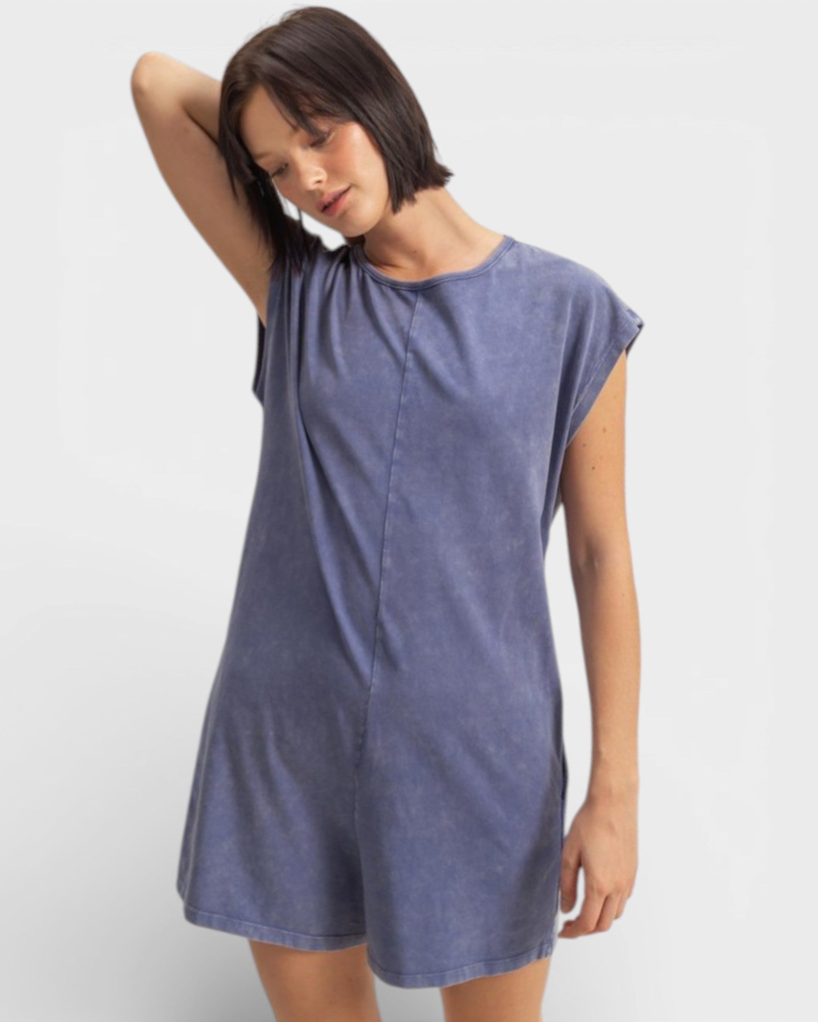 Woman wearing a blue dress against a white background