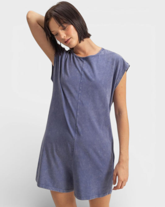 Woman wearing a blue dress against a white background